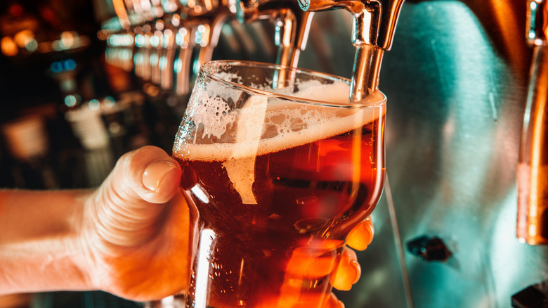 Pint of beer poured from tap