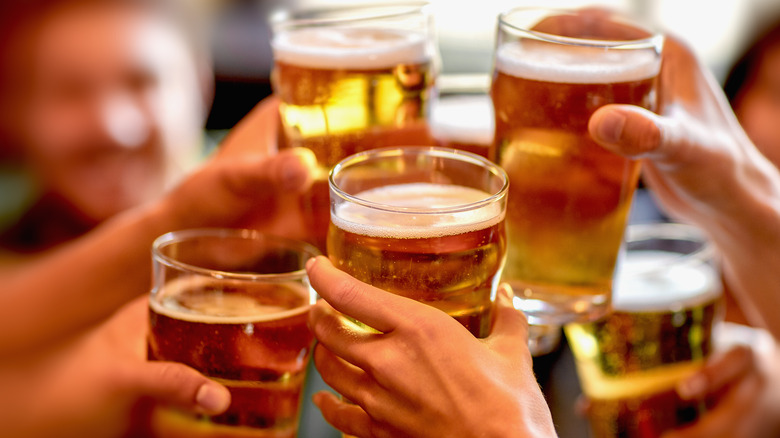 People clinking beer glasses