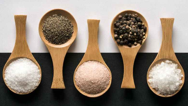 Salt and pepper on wooden spoons