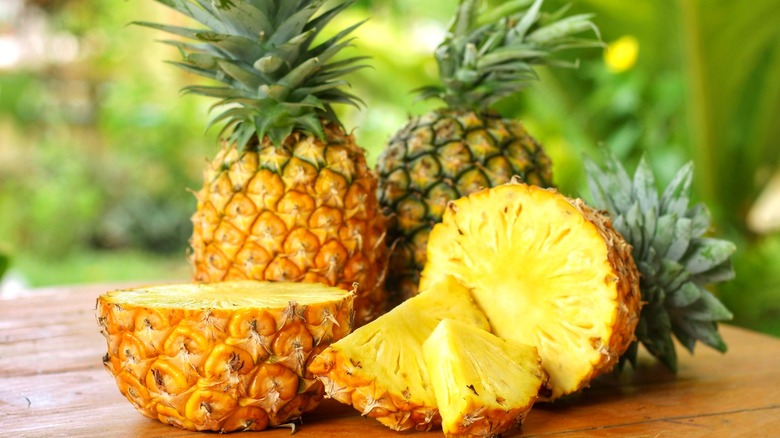 Pineapples cut in half on wooden table