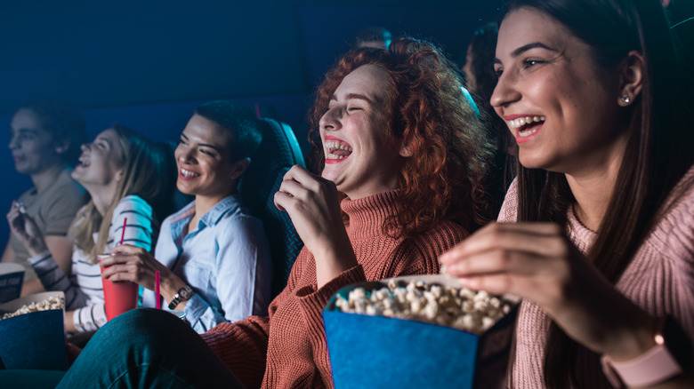 People eating popcorn in theater