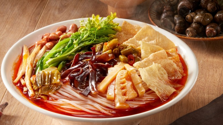 snail noodles on wooden table