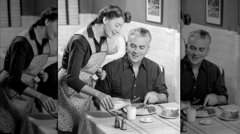 1950s woman serving man dinner