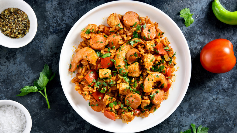 white bowl of jambalaya with spices and veggies