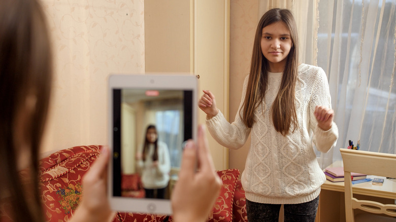 Picture of teenager being recorded on a tablet