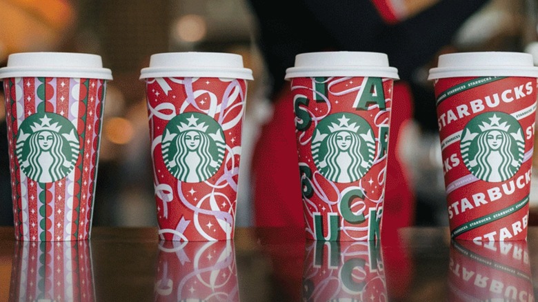 Four Starbucks red holiday cups 