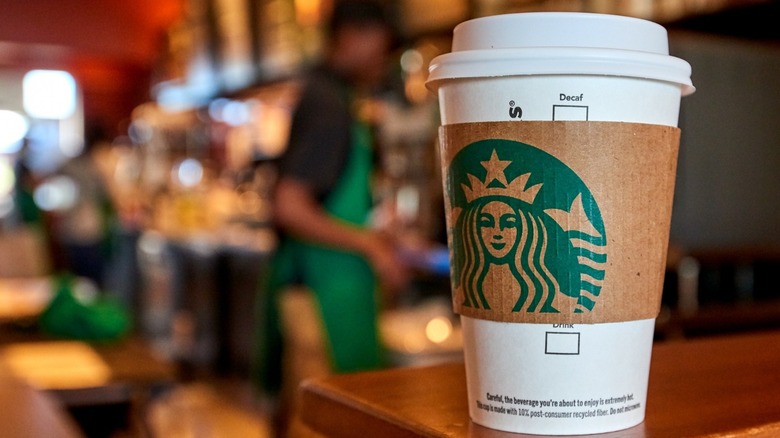 Starbucks grande cup on barista counter