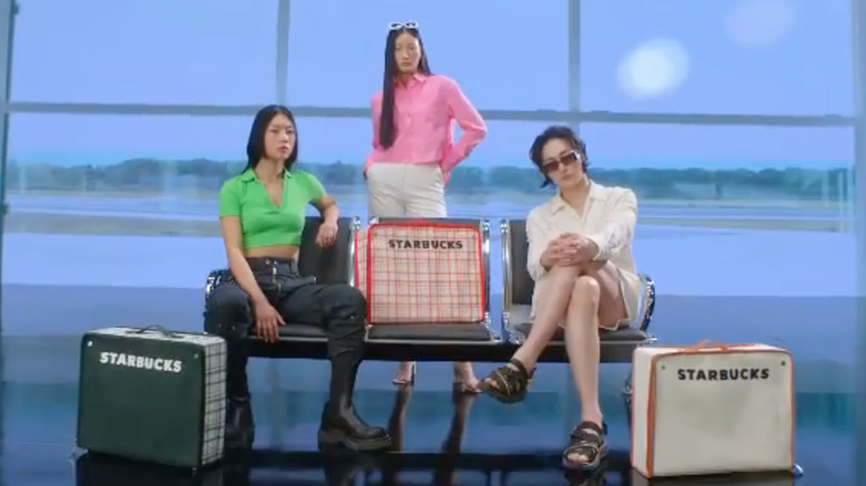 Three people with Starbucks bags 