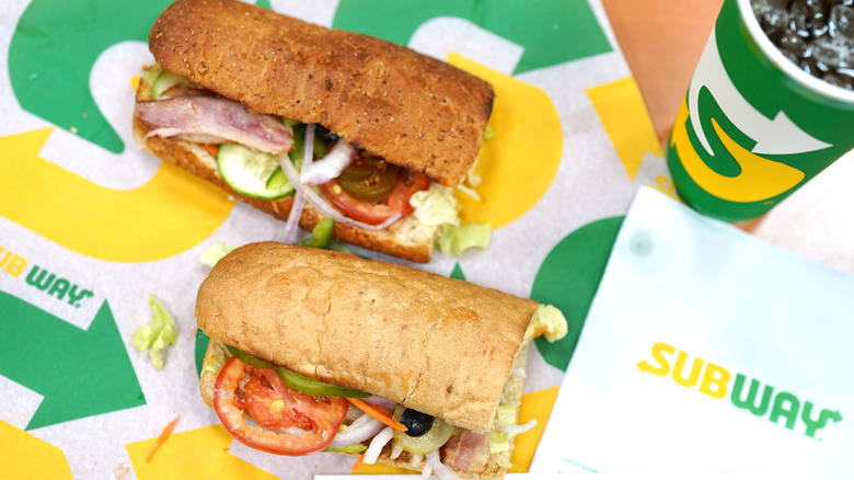 Subway sandwiches on wrappers with drink