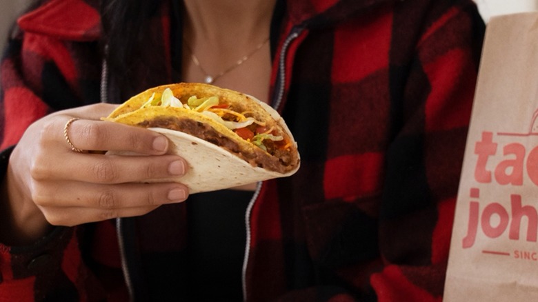 Hand holding a Taco John's Taco Bravo