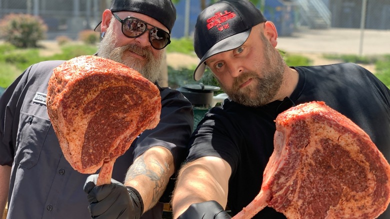 The Grill Dads holding slabs of meat