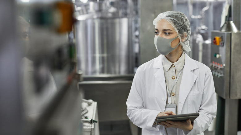 A young woman performing food safety inspection tests