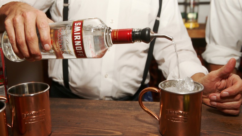 Man using Smirnoff to pour Moscow Mule