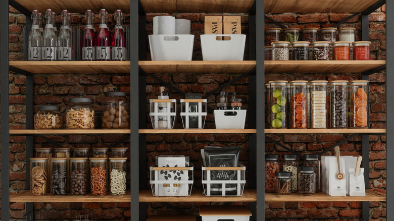 Organized pantry with bins, jars, and baskets