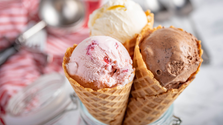 Three ice cream flavors in waffle cones 