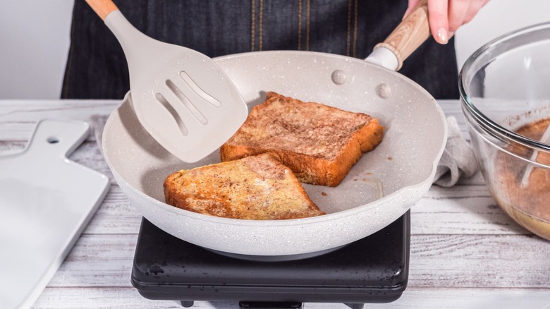Person pan-frying French toast