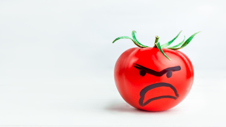 A tomato bearing an angry face 