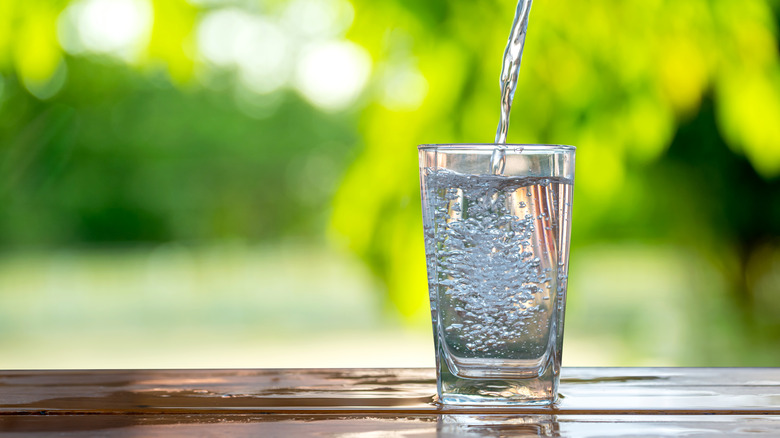 glass of water against green backgound