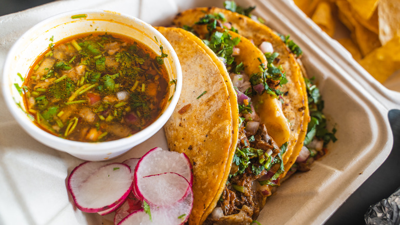 Birria tacos in container