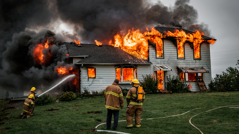 Fire fighters putting out house fire