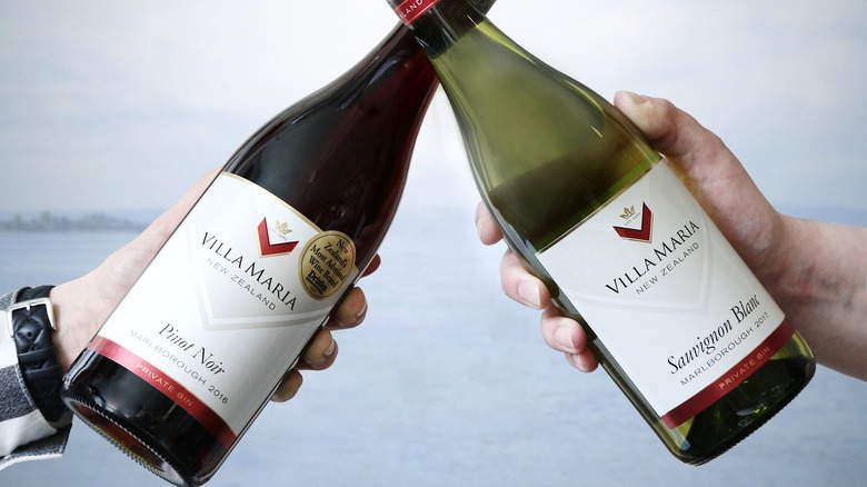 Two clinking bottles of Villa Maria Wines 