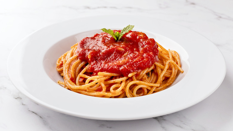 plate of spaghetti with marinara sauce