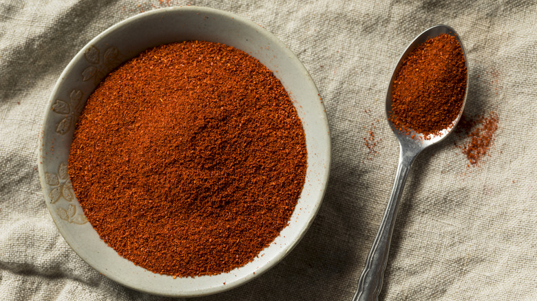 Smoked paprika in a bowl with spoon