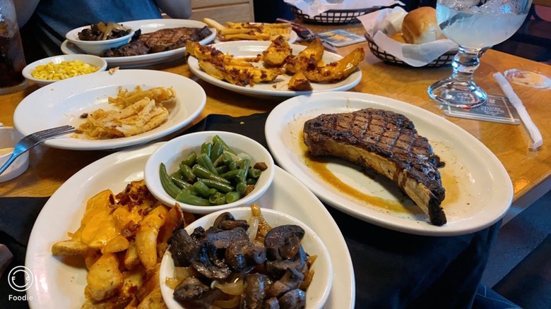 steak and side dishes on table at Texas Roadhouse restaurant