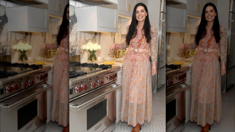 Katie Lee Biegel cooking by a kitchen stove