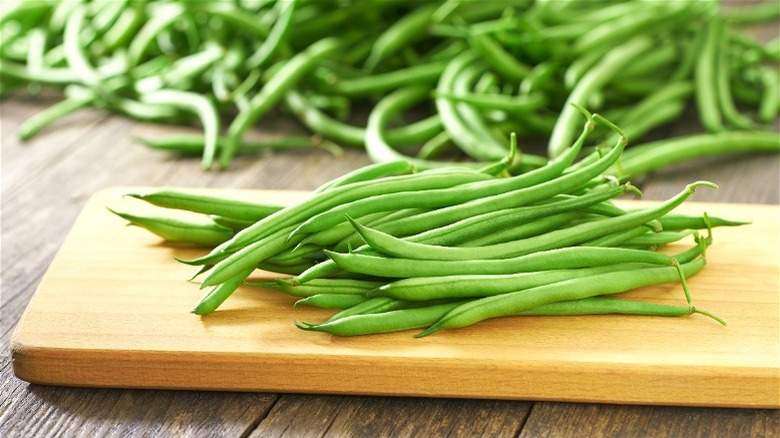 Fresh green beans on cutting board