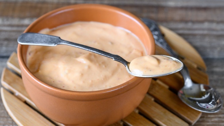 Burger sauce in a bowl with a silver spoon on top of the bowl