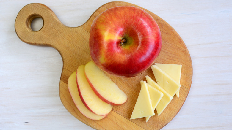 apple and cheese on a cutting board