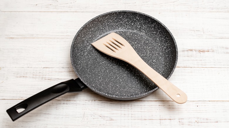 ceramic pan on a table with a wooden spoon