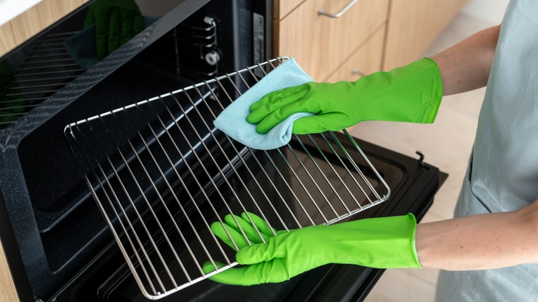 Person cleaning oven rack