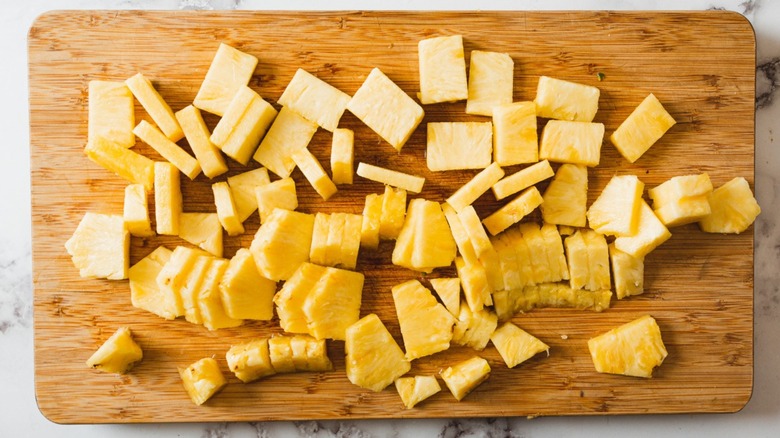 pineapple pieces on cutting board