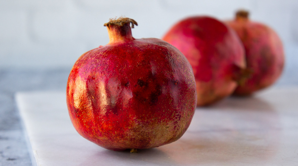 a pomegranate on white granite