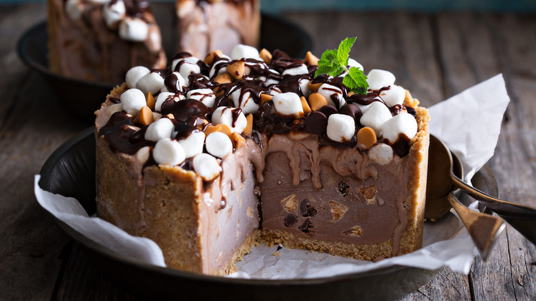 An ice cream cake with slices cut out of it