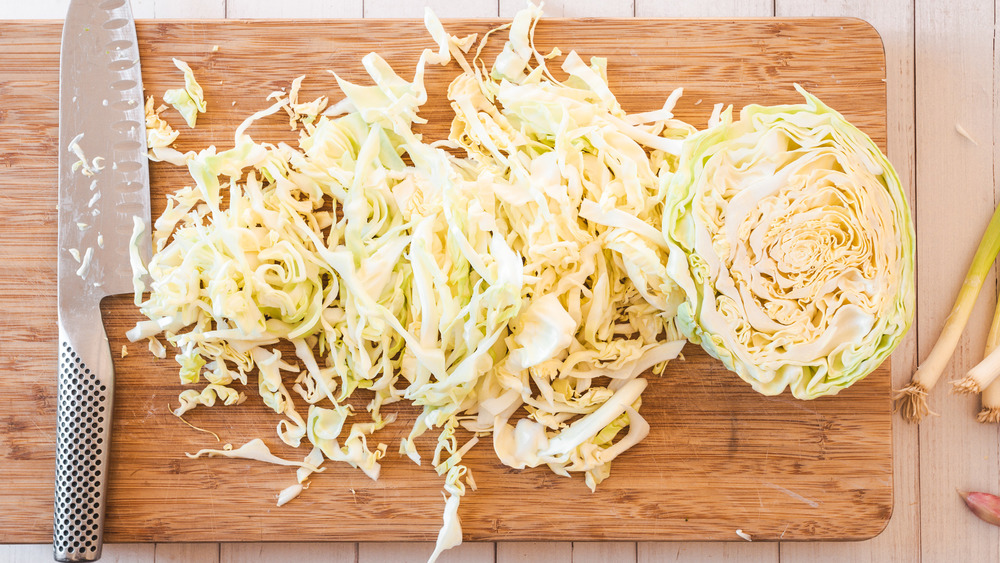 sliced cabbage on cutting board with knife