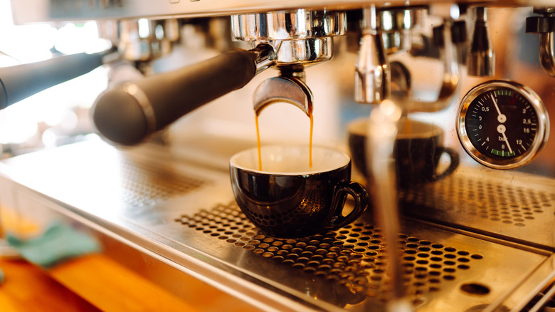 An espresso machine makes a fresh espresso.