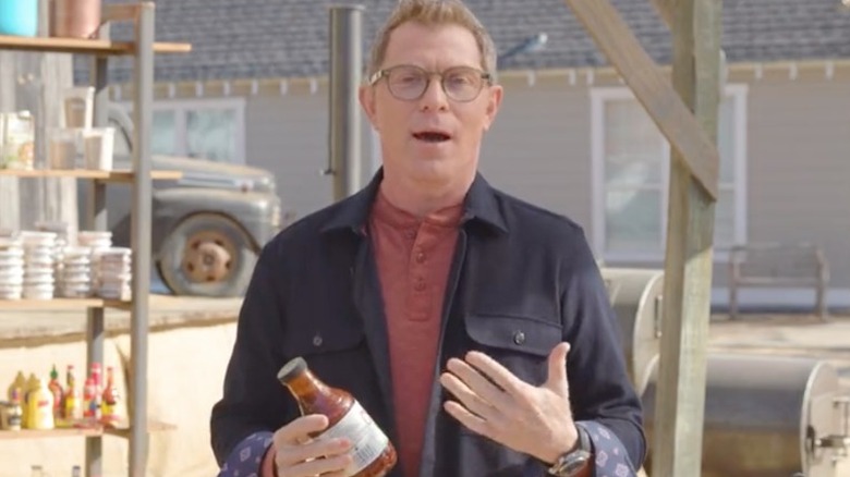 Bobby Flay holding bbq sauce