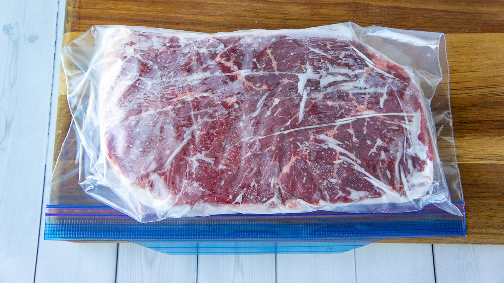 a frozen steak in a zip top bag