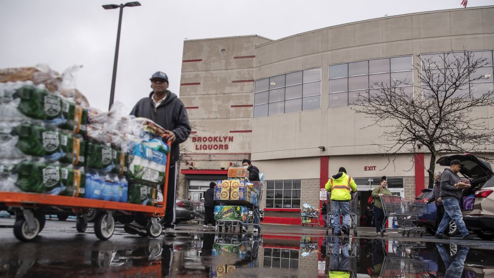 person with shopping cart leaving Costco
