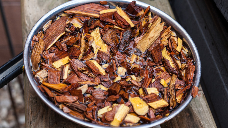 Soaked wood chips in an aluminum tray