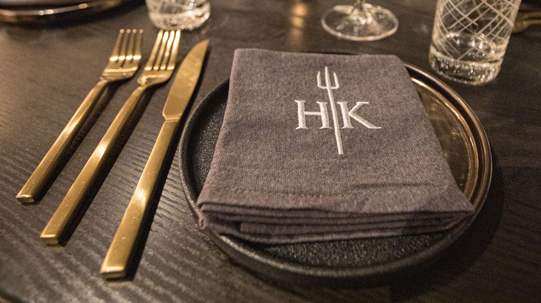 A place setting with Hell's Kitchen monogrammed napkin