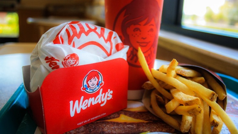 Wendy's burger, fries, and drink on a tray
