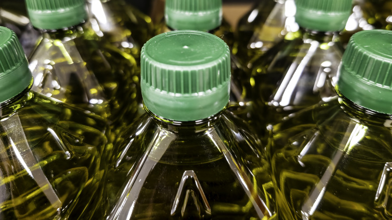 The tops pof several plastic olive oil bottles