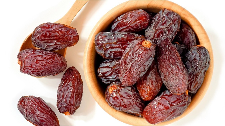 Dates in a bowl on on spoon