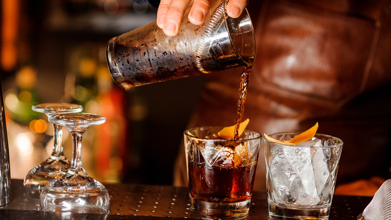 A bartender pouring drinks