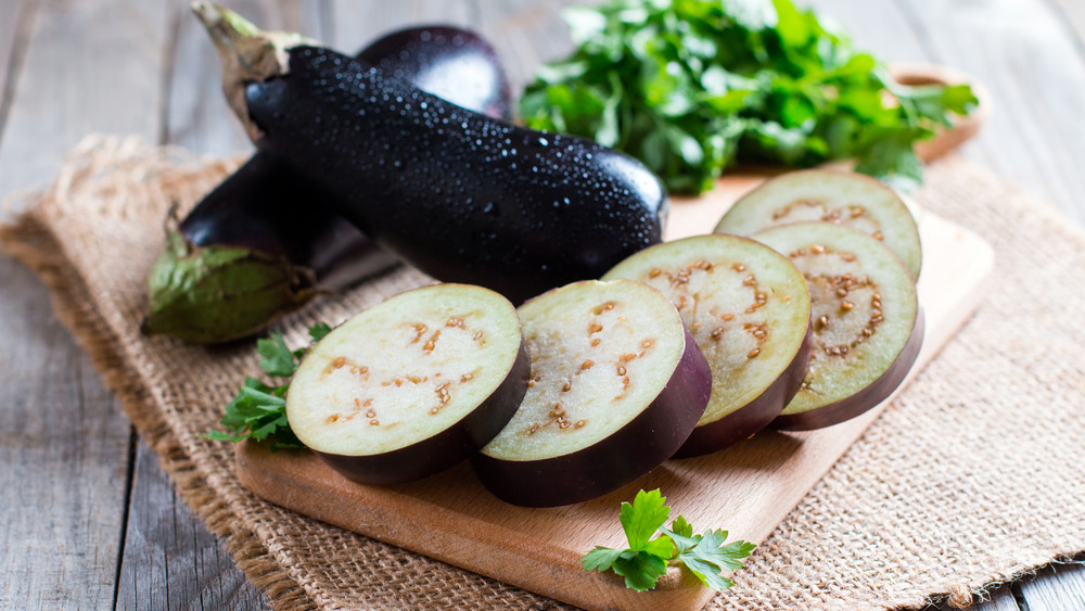 Eggplant sliced up on a board