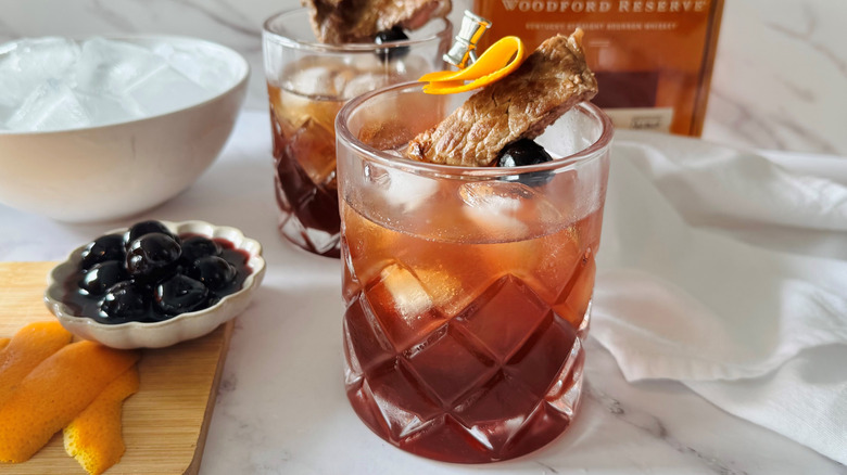Manhattan cocktails with steak garnishes